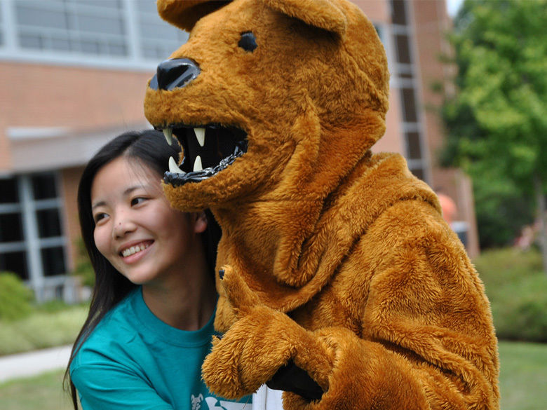 A female college student hugging the Nittany Lion mascot